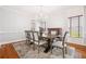 Elegant dining room featuring a modern chandelier, large table, and soft gray rug at 1121 Vinings Grove Se Way, Smyrna, GA 30082