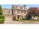 Charming brick two-story home with a well-manicured lawn and attached two-car garage at 1121 Vinings Grove Se Way, Smyrna, GA 30082