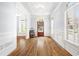 Inviting foyer with hardwood floors, wainscoting, large window, and wood door at 1121 Vinings Grove Se Way, Smyrna, GA 30082