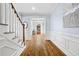 Elegant foyer with hardwood floors, staircase, wainscoting, and an arched entryway at 1121 Vinings Grove Se Way, Smyrna, GA 30082
