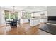 Open kitchen with an island, breakfast nook, large windows, and hardwood flooring at 1121 Vinings Grove Se Way, Smyrna, GA 30082