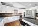 Bright kitchen with white cabinets, stainless steel appliances and granite countertops and island with breakfast bar at 1121 Vinings Grove Se Way, Smyrna, GA 30082