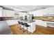 Spacious kitchen features white cabinets, stainless steel appliances, a center island, and hardwood floors at 1121 Vinings Grove Se Way, Smyrna, GA 30082