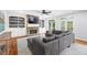 Open living room boasts a stone fireplace, built-in bookshelves, a gray sectional sofa, and hardwood floors at 1121 Vinings Grove Se Way, Smyrna, GA 30082
