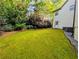 View of expansive green backyard lawn, exterior of the home, and lush landscaping at 3803 Upland Dr, Marietta, GA 30066