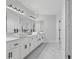Bright bathroom featuring double sinks, a large mirror, and marble floors at 3803 Upland Dr, Marietta, GA 30066