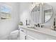 Serene bathroom with modern fixtures, elegant mirror, white vanity, and natural light for a spa-like experience at 3803 Upland Dr, Marietta, GA 30066