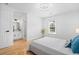 Well-lit bedroom boasting hardwood floors, a comfortable bed, and an adjacent bathroom, perfect for relaxation at 3803 Upland Dr, Marietta, GA 30066