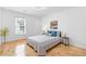 Bright bedroom with hardwood floors, comfy bed, and natural light creating a relaxing and inviting space at 3803 Upland Dr, Marietta, GA 30066