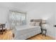Cozy bedroom featuring hardwood floors, a comfortable bed, natural light, and a peaceful ambiance at 3803 Upland Dr, Marietta, GA 30066