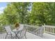Enjoy this lovely grey deck furnished with a glass table and chairs, overlooking serene green trees at 3803 Upland Dr, Marietta, GA 30066