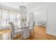 Bright dining room with hardwood floors, elegant chandelier, and a view into the foyer at 3803 Upland Dr, Marietta, GA 30066
