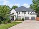 Charming two-story home with a well-manicured lawn and a spacious two-car garage at 3803 Upland Dr, Marietta, GA 30066