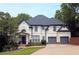 Inviting two-story home featuring a manicured lawn, tasteful landscaping, and a convenient two-car garage at 3803 Upland Dr, Marietta, GA 30066