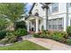 Beautiful front yard features lush landscaping leading up to the stately entrance of the home at 3803 Upland Dr, Marietta, GA 30066