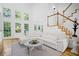 Light-filled living room with large windows and wood staircase at 3803 Upland Dr, Marietta, GA 30066