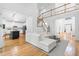 Open-concept living room with white sofa and island with bar stools at 3803 Upland Dr, Marietta, GA 30066