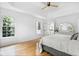 Bright main bedroom with wood floors, ceiling fan, and windows overlooking wooded area at 3803 Upland Dr, Marietta, GA 30066