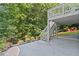 Wide outdoor patio featuring stairs to the wooden deck above and relaxing red Adirondack chairs on the lawn at 3803 Upland Dr, Marietta, GA 30066