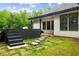Landscaped backyard featuring stone pathway and steps up to an outdoor patio area at 5264 Prestley Crossing Ln, Douglasville, GA 30135