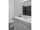 Bathroom with a marble countertop, vanity, and large mirror above the sink at 5264 Prestley Crossing Ln, Douglasville, GA 30135
