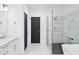 Bathroom with a large glass shower, white marble countertops, and modern black hardware at 5264 Prestley Crossing Ln, Douglasville, GA 30135
