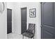 Hallway featuring marble flooring, a tufted chair, and modern art on the walls at 5264 Prestley Crossing Ln, Douglasville, GA 30135