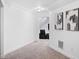 Hallway boasts neutral carpet and fresh white walls, adorned with modern art pieces at 5264 Prestley Crossing Ln, Douglasville, GA 30135