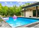 Backyard pool with lush landscaping perfect for relaxation and entertainment at 5264 Prestley Crossing Ln, Douglasville, GA 30135