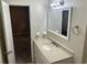 Bathroom features a single sink vanity with a mirror at 8415 Magnolia Dr, Jonesboro, GA 30238