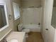 Full bathroom features a shower-tub combo, tile flooring, and white fixtures at 8415 Magnolia Dr, Jonesboro, GA 30238