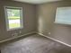 Bedroom features neutral carpet and bright natural light from dual windows at 8415 Magnolia Dr, Jonesboro, GA 30238