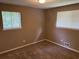 Bedroom features neutral carpet and bright natural light from dual windows at 8415 Magnolia Dr, Jonesboro, GA 30238