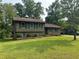 Traditional two-story home with a well-maintained lawn, brick accents, and mature trees at 8415 Magnolia Dr, Jonesboro, GA 30238