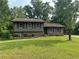 Split level home with green lawn, and brick/vinyl siding at 8415 Magnolia Dr, Jonesboro, GA 30238