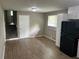 Kitchen features laminate flooring, stainless steel sink, and adjacent staircase at 8415 Magnolia Dr, Jonesboro, GA 30238