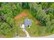 Wide aerial view of a property surrounded by lush forest and a cleared lot at 190 Paul Aiken Rd, Dallas, GA 30157