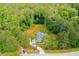 Aerial view of a home surrounded by mature trees with a long, winding driveway at 190 Paul Aiken Rd, Dallas, GA 30157
