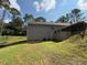 Side view of the backyard featuring a gentle slope, mature trees, green grass, and gray siding at 190 Paul Aiken Rd, Dallas, GA 30157