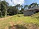 Large backyard with mature trees, green grass and an area of fresh topsoil at 190 Paul Aiken Rd, Dallas, GA 30157