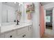Bright bathroom featuring vanity and modern fixtures, marble counters, and access to bedroom at 190 Paul Aiken Rd, Dallas, GA 30157
