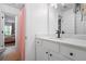 Bathroom featuring marble vanity, decorative shelving, and a doorway view to bedroom at 190 Paul Aiken Rd, Dallas, GA 30157