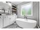 Bathroom featuring a soaking tub, modern fixtures, and white cabinetry at 190 Paul Aiken Rd, Dallas, GA 30157