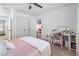 Bright bedroom featuring a double closet and neutral-toned decor with a ceiling fan and white trim at 190 Paul Aiken Rd, Dallas, GA 30157
