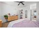 Bright bedroom featuring a window and neutral-toned decor with a ceiling fan and white trim at 190 Paul Aiken Rd, Dallas, GA 30157