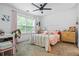 Cozy bedroom featuring a window and neutral-toned decor with a ceiling fan and white trim at 190 Paul Aiken Rd, Dallas, GA 30157