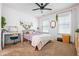 Bright bedroom featuring a window and neutral-toned decor with a ceiling fan, a desk and white trim at 190 Paul Aiken Rd, Dallas, GA 30157