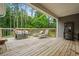 Relaxing deck area overlooking the forest featuring lounge chairs and a grill stand at 190 Paul Aiken Rd, Dallas, GA 30157