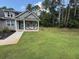 Inviting home with a spacious front yard and covered porch, nestled amidst towering trees and lush landscaping at 190 Paul Aiken Rd, Dallas, GA 30157