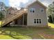 Exterior rear of home featuring multiple windows, wooden deck and stairs at 190 Paul Aiken Rd, Dallas, GA 30157